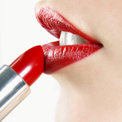 woman applying red lipstick
